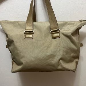 Tumi gold Duffel from the vista collection.